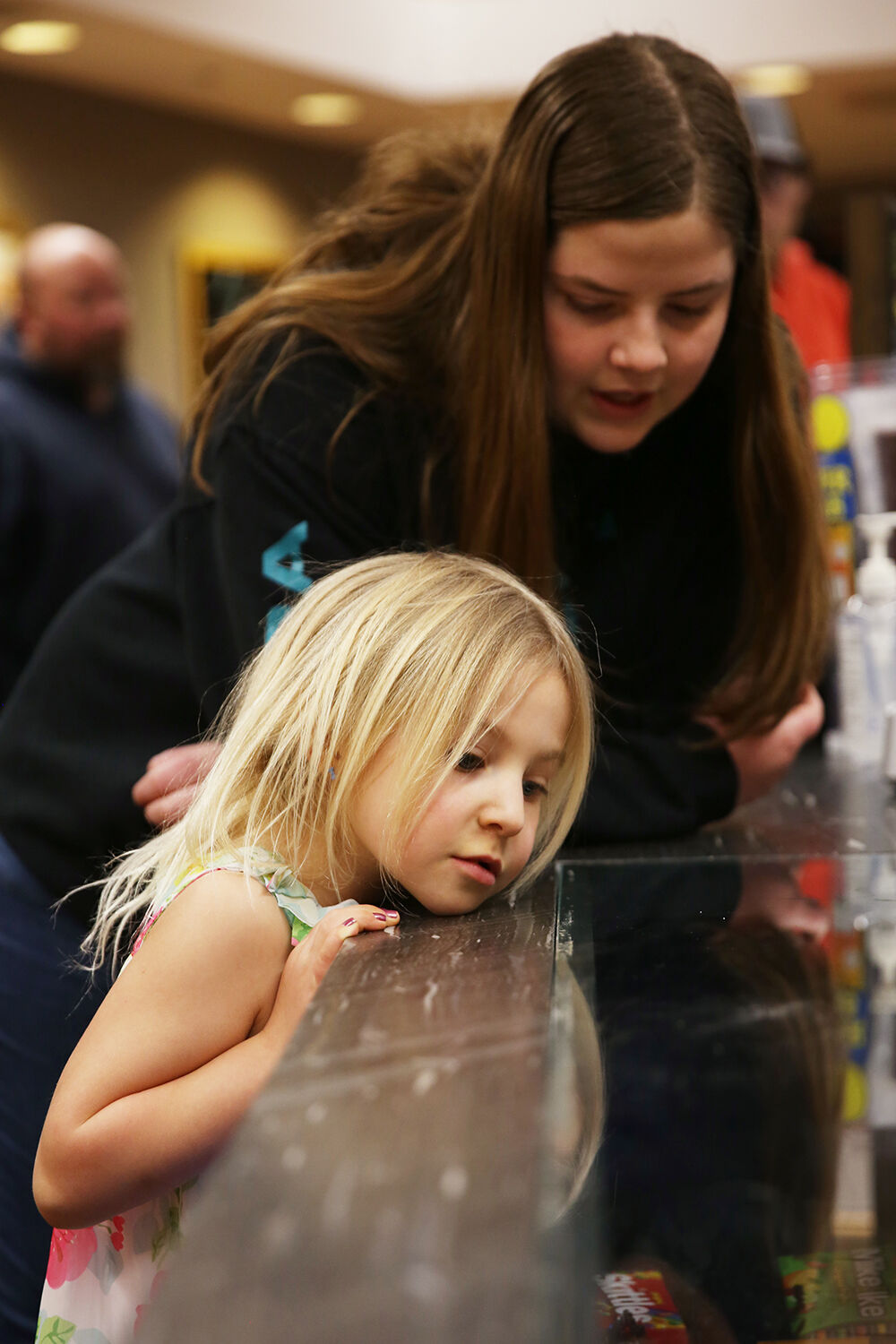 Brexlie Wolski, 5, looks through the glass to pick out a candy